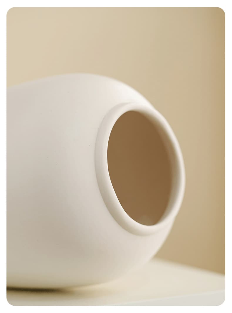 Close-up of the opening on a white ceramic table vase