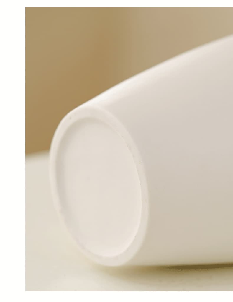 Close-up of the base on a minimalist white ceramic vase