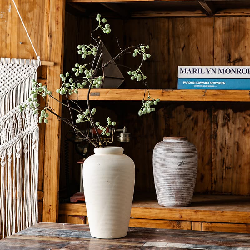 Silent antique ceramic vases styled on a rustic shelf