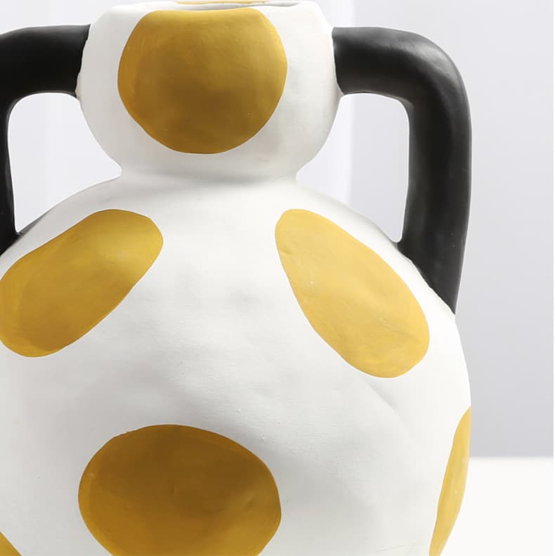 Cream milk pot ceramic vase close-up with mustard dot pattern
