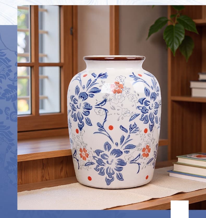 Tall blue porcelain vase displayed by a window