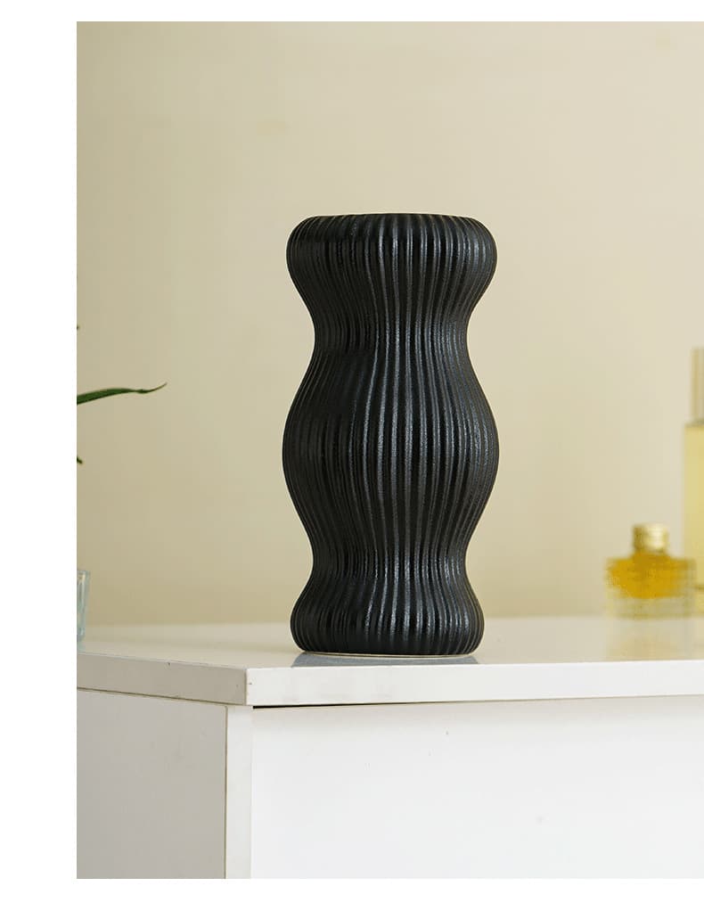 Black small waist ceramic vase on a shelf
